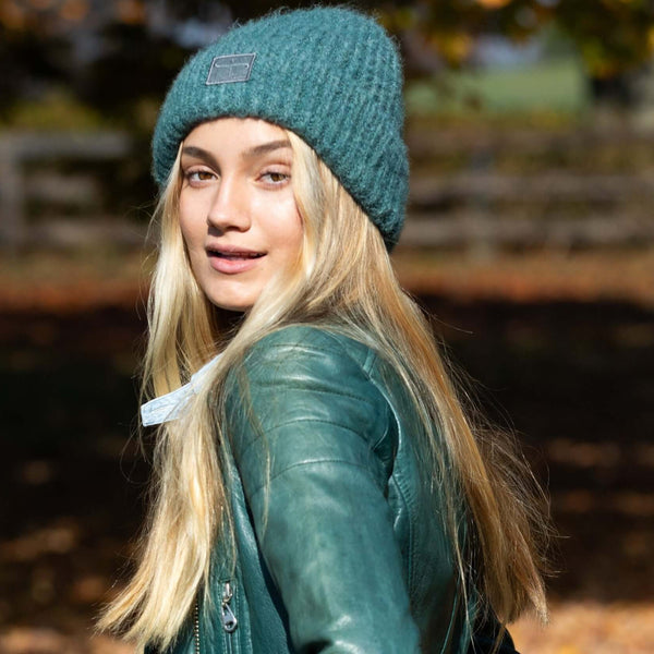  Woman wearing the Eco Jane Beanie in Teal exploring the outdoors