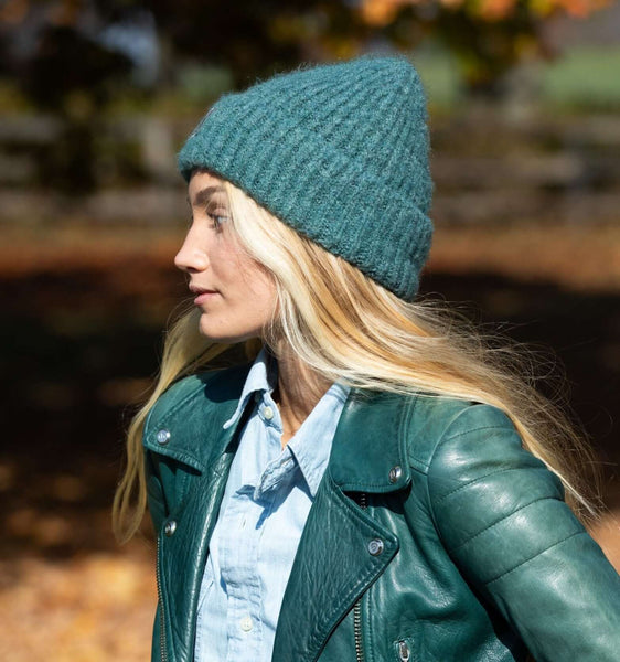 Woman wearing the Eco Jane Beanie, standing outdoors in a forest